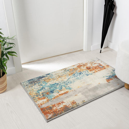 abstract colorful doormat on a white floor in front of door