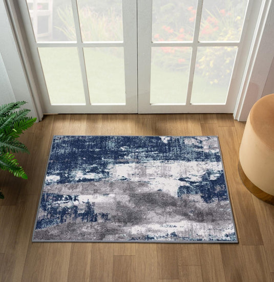 abstract blue doormat on a wooden floor in front of door