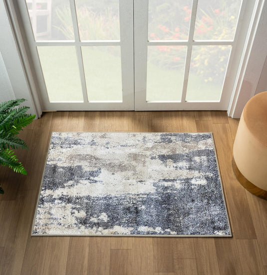 abstract gray small rug on a wooden floor in front of door