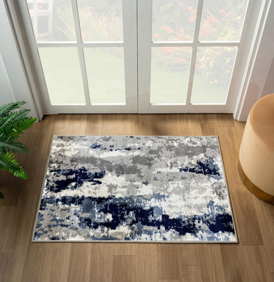 Abstract ivory patterned rug on a wooden floor with a large window in the background