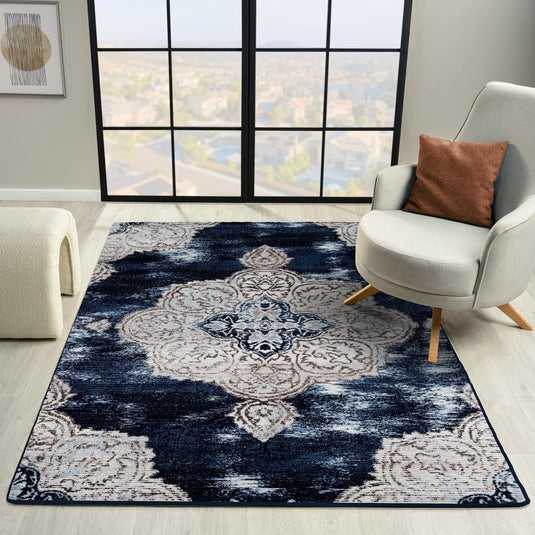 Blue and white patterned rug in a room with a chair and window
