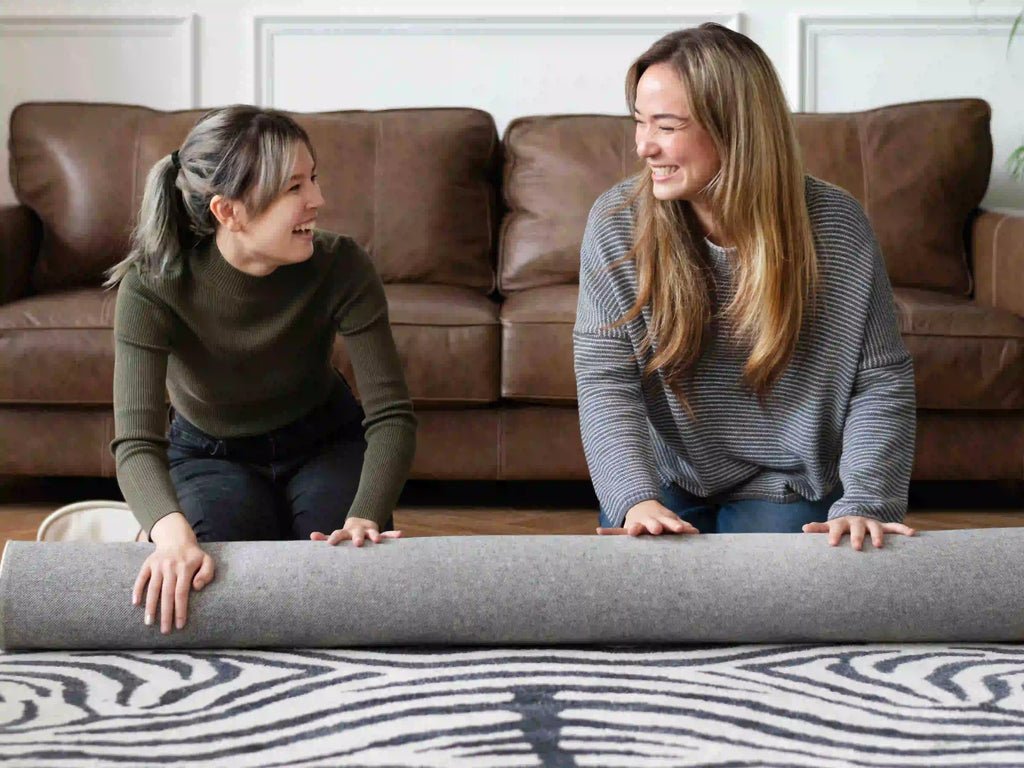 ladies flattening a rug