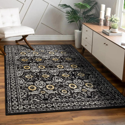 Decorative rug with floral pattern on a wooden floor in a room with furniture and decor.