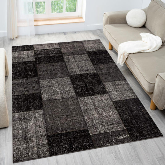 Checkered area rug in a living room with a beige sofa and window in the background.